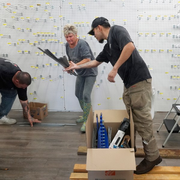 Employees at The Goodz hardware store, remove all the merchandise in advance of Hurricane Milton, Monday, Oct. 7, 2024, in Fort Myers Beach, Fla. (AP Photo/Marta Lavandier)