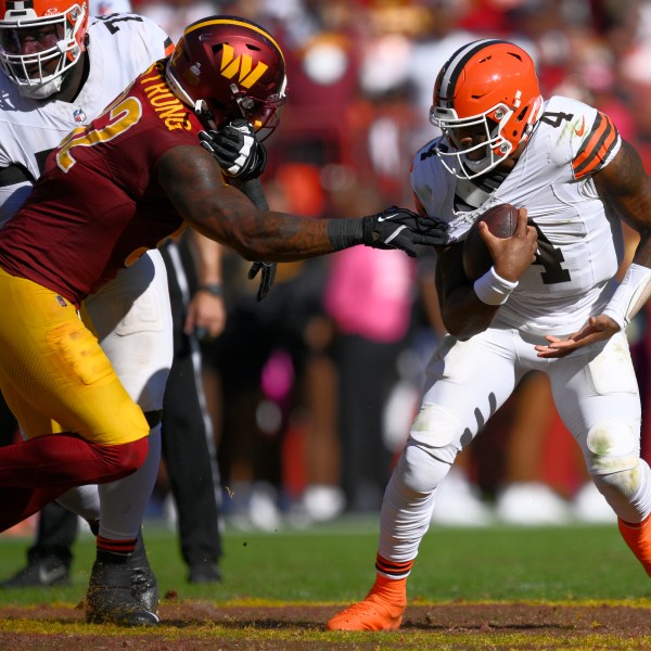 Cleveland Browns quarterback Deshaun Watson (4) break away from Washington Commanders defensive end Dorance Armstrong (92) during the second half of an NFL football game in Landover, Md., Sunday, Oct. 6, 2024. (AP Photo/Nick Wass)