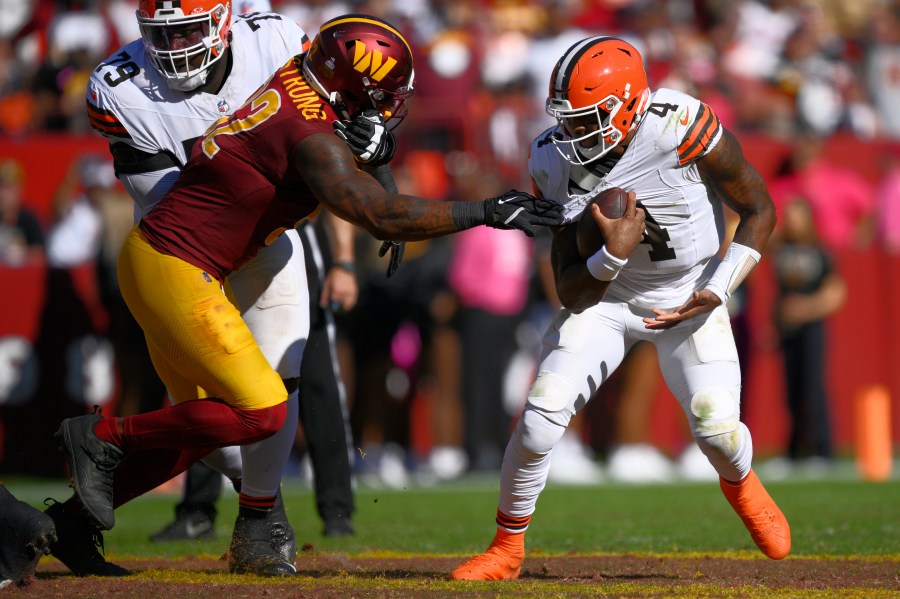 Cleveland Browns quarterback Deshaun Watson (4) break away from Washington Commanders defensive end Dorance Armstrong (92) during the second half of an NFL football game in Landover, Md., Sunday, Oct. 6, 2024. (AP Photo/Nick Wass)