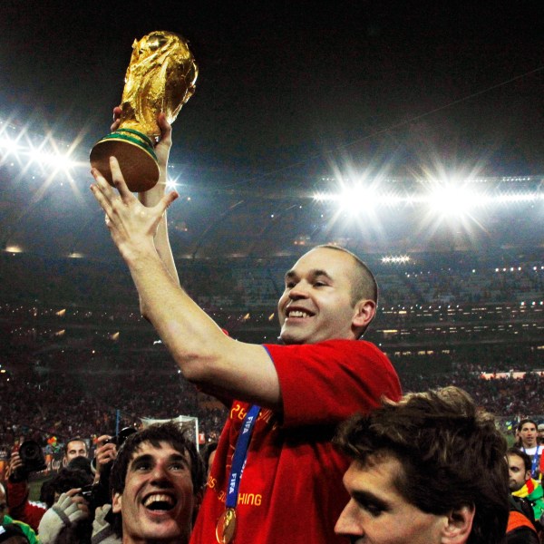 FILE - Spain's Andres Iniesta holds up the World Cup trophy after the World Cup final soccer match between the Netherlands and Spain at Soccer City in Johannesburg, South Africa, July 11, 2010. Andres Iniesta who scored Spain's World Cup-winning goal in 2010 and was one of the key players who made Barcelona's tiki-taka thrive for so long, announced his retirement from soccer on Tuesday. (AP Photo/Bernat Armangue, File)