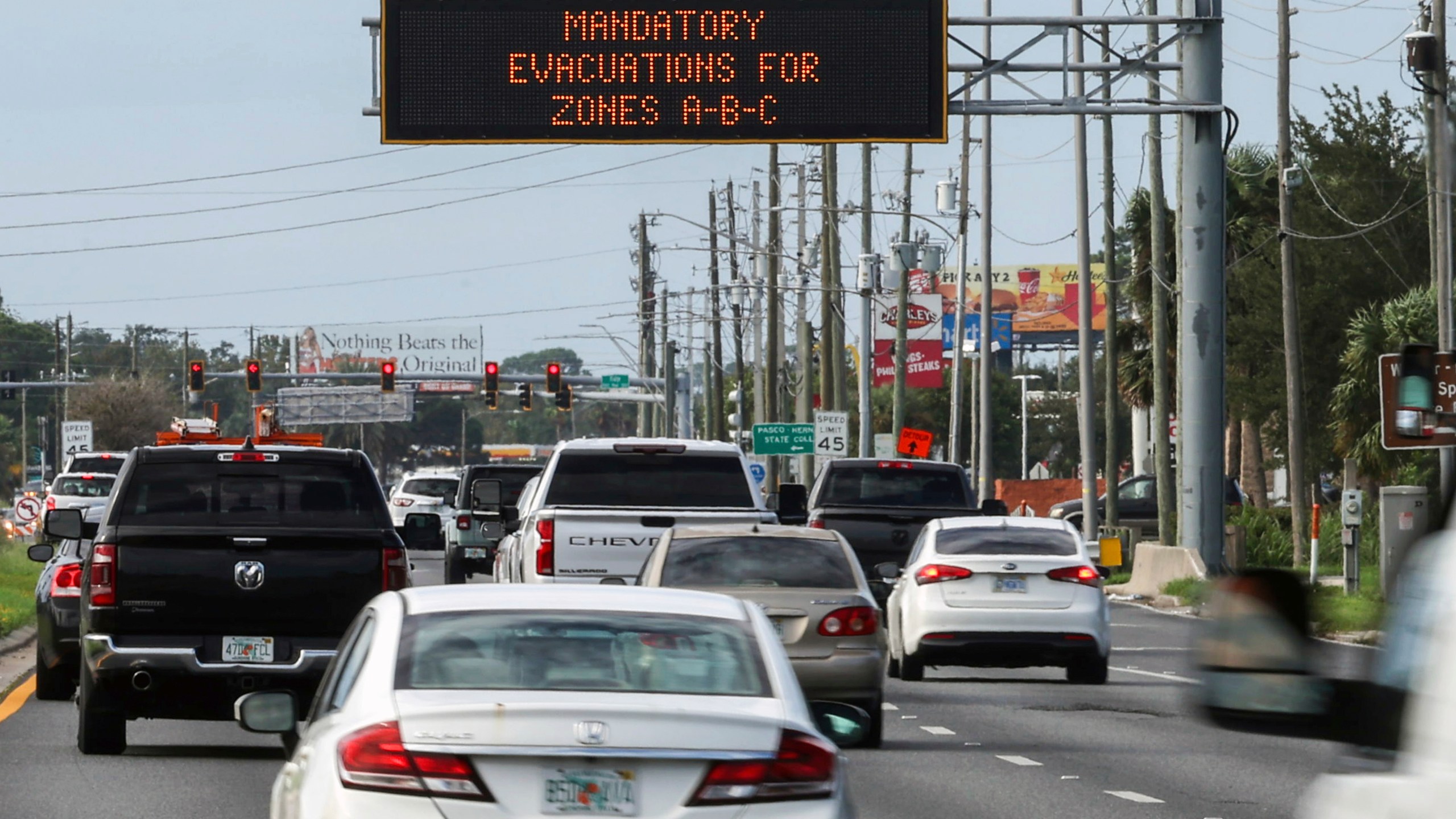 Highway signage announces the impending arrival of Hurricane Milton and the evacuations zones on Tuesday, Oct. 8, 2024, in Port Richey, Fla. (AP Photo/Mike Carlson)