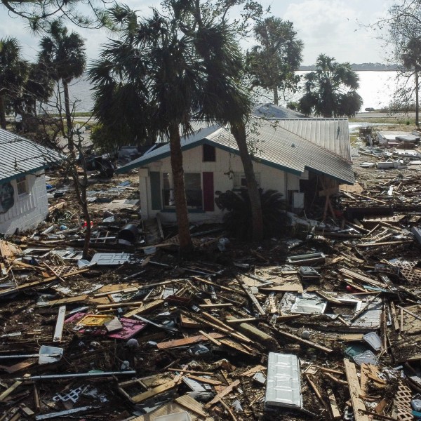 FILE - Debris surrounds the Faraway Inn Cottages and Motel in the aftermath of Hurricane Helene, in Cedar Key, Fla., Sept. 27, 2024. (AP Photo/Stephen Smith, File)