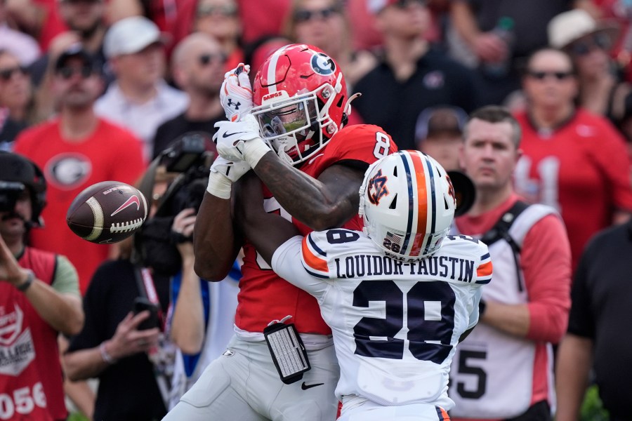 Auburn safety Kensley Louidor-Faustin (28) breaks up a pass intended for Georgia wide receiver Colbie Young (8) in the first half of an NCAA college football game Saturday, Oct. 5, 2024, in Athens, Ga. (AP Photo/John Bazemore)