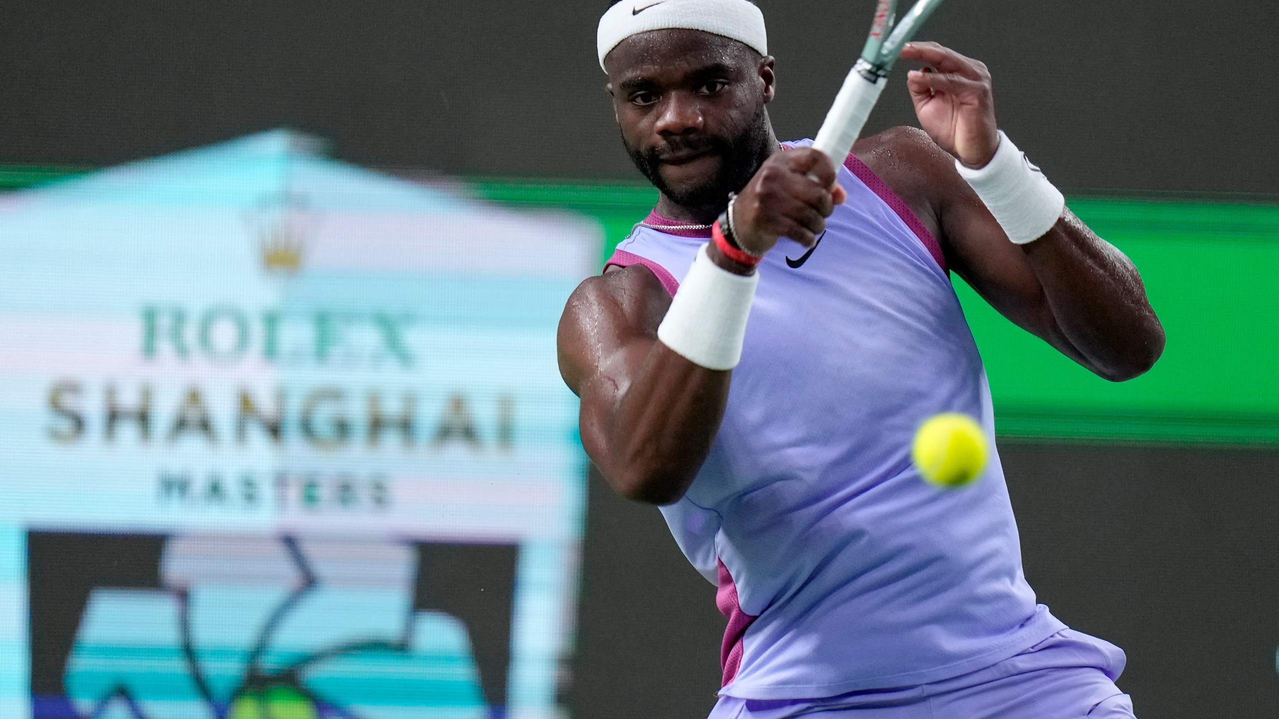 Frances Tiafoe of the United States returns a shot to Zhou Yi of China during the men's singles second round match in the Shanghai Masters tennis tournament at Qizhong Forest Sports City Tennis Center in Shanghai, China, Monday, Oct. 7, 2024. (AP Photo/Andy Wong)