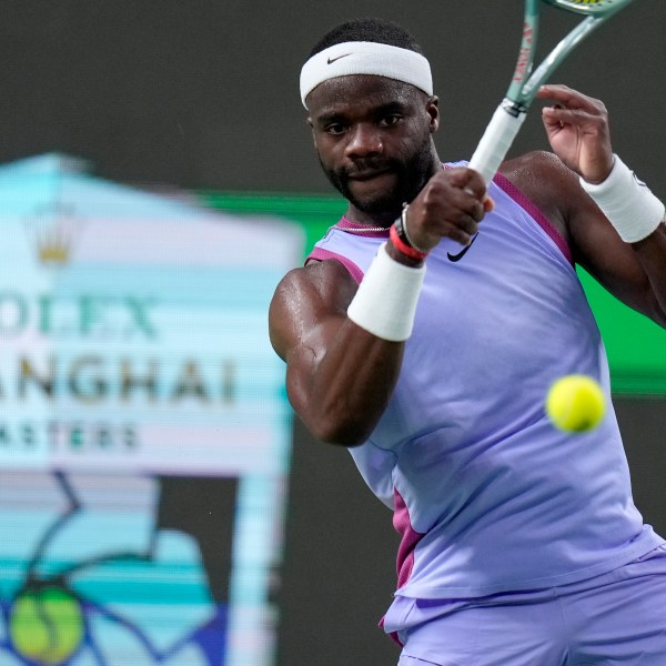 Frances Tiafoe of the United States returns a shot to Zhou Yi of China during the men's singles second round match in the Shanghai Masters tennis tournament at Qizhong Forest Sports City Tennis Center in Shanghai, China, Monday, Oct. 7, 2024. (AP Photo/Andy Wong)