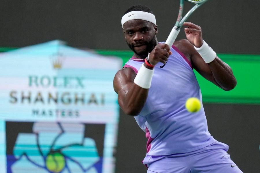 Frances Tiafoe of the United States returns a shot to Zhou Yi of China during the men's singles second round match in the Shanghai Masters tennis tournament at Qizhong Forest Sports City Tennis Center in Shanghai, China, Monday, Oct. 7, 2024. (AP Photo/Andy Wong)