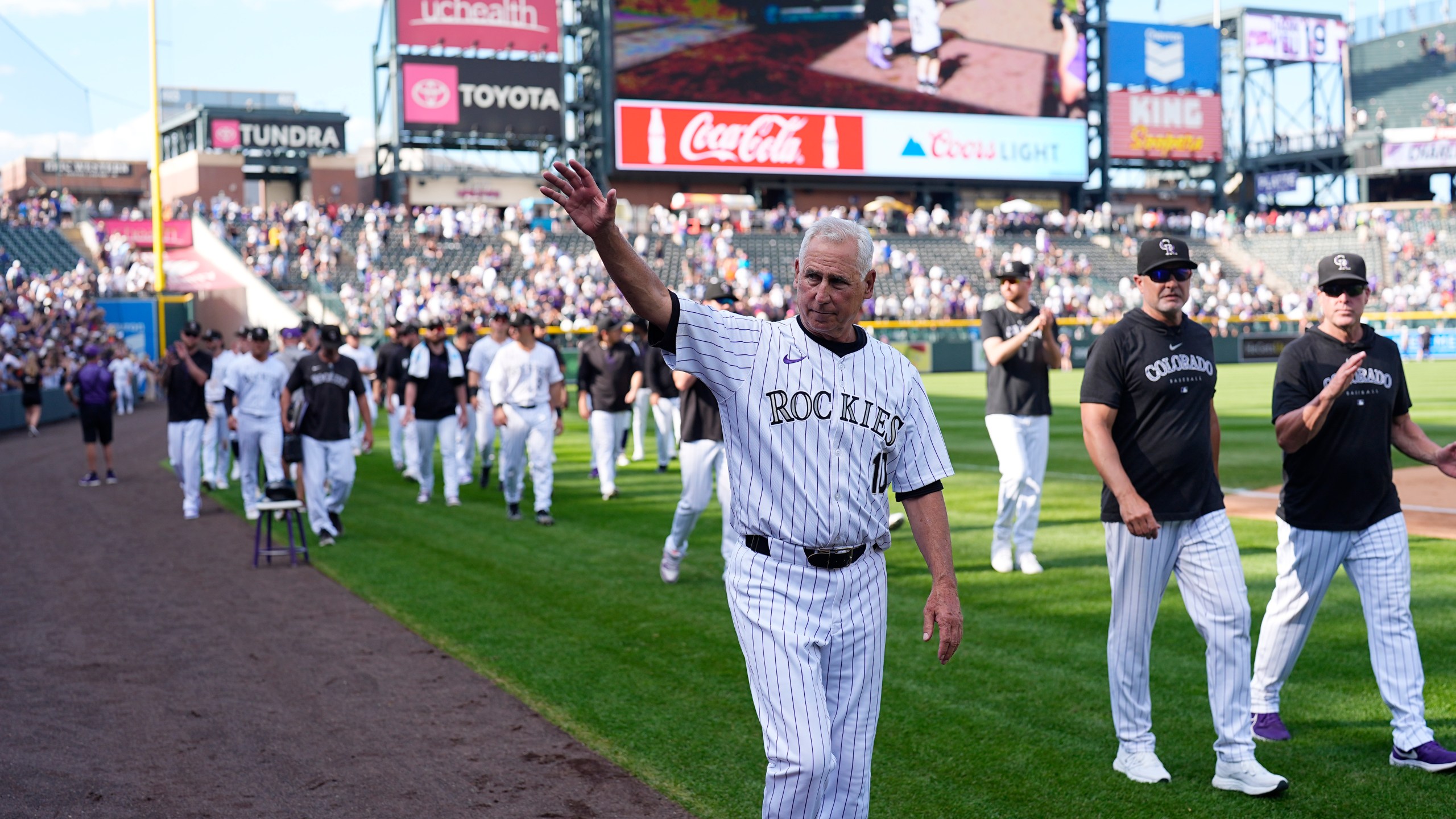 Colorado Rockies manager Bud Black waves to the crowd during the team's ceremonial walk around the field to acknowledge fans following a loss in the team's season finale Sunday, Sept. 29, 2024, in Denver. (AP Photo/David Zalubowski)