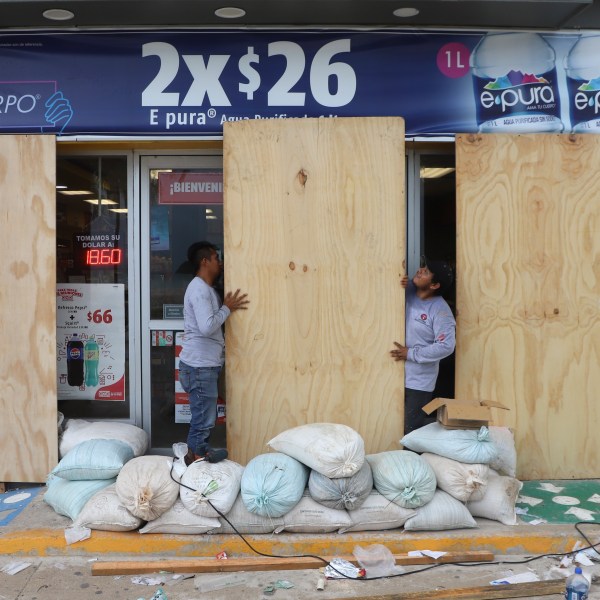 FILE - Workers board up a grocery store to protect it from Hurricane Milton, in Progreso, Yucatan state, Mexico, Oct. 7, 2024. (AP Photo/Martin Zetina, File)