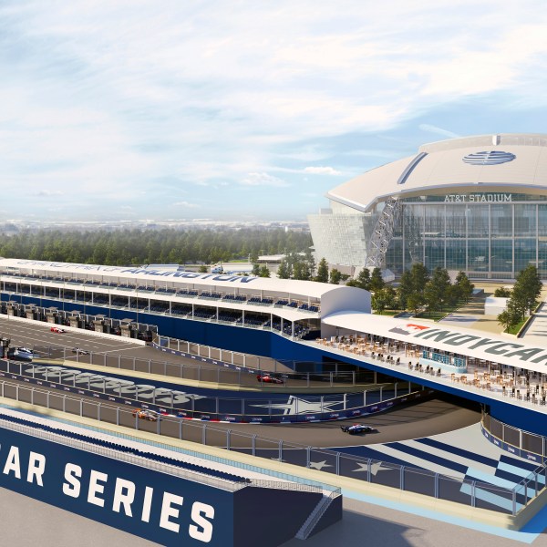 This artists rendering provided by IndyCar shows a race car passing stands for spectators during an IndyCar race near AT&T Stadium in Arlington, Texas. (IndyCar via AP )