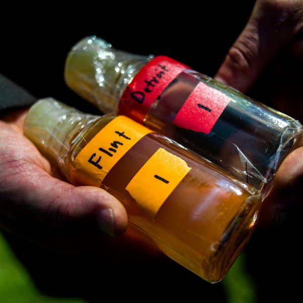 FILE - Virginia Tech professor Marc Edwards shows the difference in water quality between Detroit and Flint after testing, giving evidence after more than 270 samples were sent in from Flint that show high levels of lead during a news conference on Sept. 15, 2015, in downtown Flint, Mich. (Jake May/The Flint Journal via AP, File)