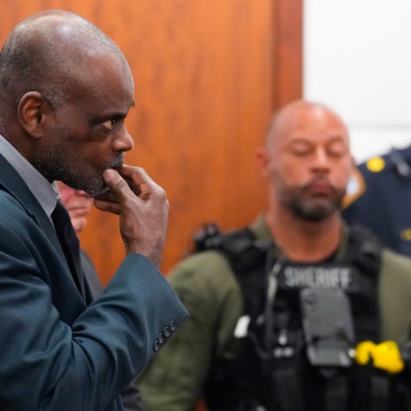 Former Houston Police officer Gerald Goines stands as he is formally sentenced on a pair of felony murder convictions on Tuesday, Oct. 8, 2024, in Houston. Goines was found guilty of felony murder and sentenced to 60 years behind bars in the 2019 deaths of Dennis Tuttle and Rhogena Nicholas. (Brett Coomer/Houston Chronicle via AP)