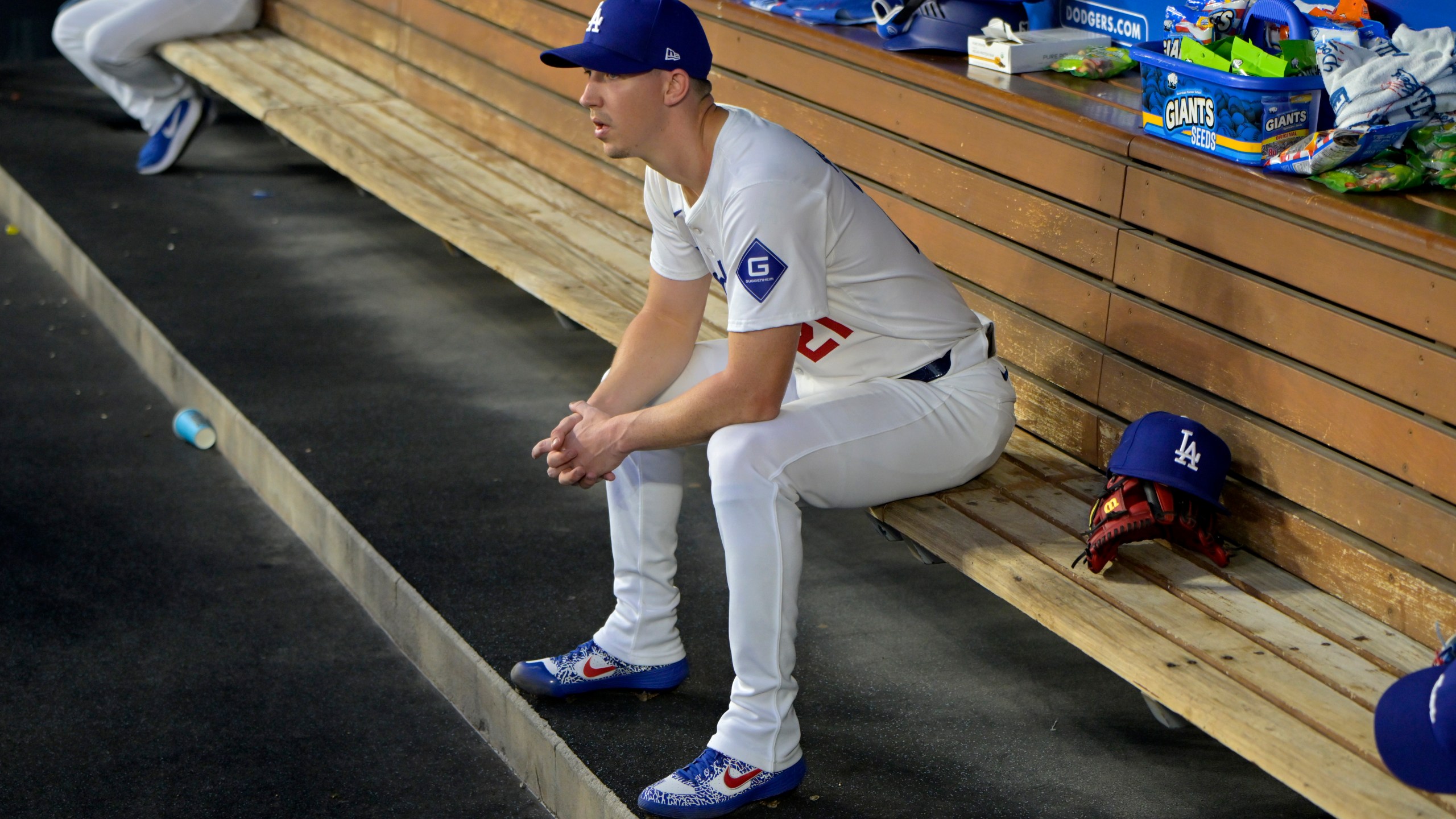 FILE - Los Angeles Dodgers' Walker Buehler sits in the dugout after the first inning of a baseball game against the Seattle Mariners, Tuesday, Aug. 20, 2024, in Los Angeles. (AP Photo/Jayne-Kamin-Oncea, File)