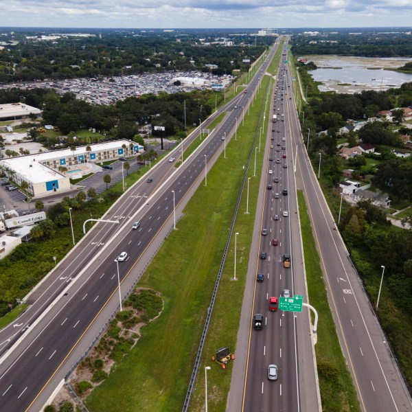 In this image taken with a drone, traffic flows eastbound along Interstate 4 as residents continue to follow evacuation orders ahead of Hurricane Milton, Tuesday, Oct. 8, 2024, in Tampa, Fla. (AP Photo/Julio Cortez)