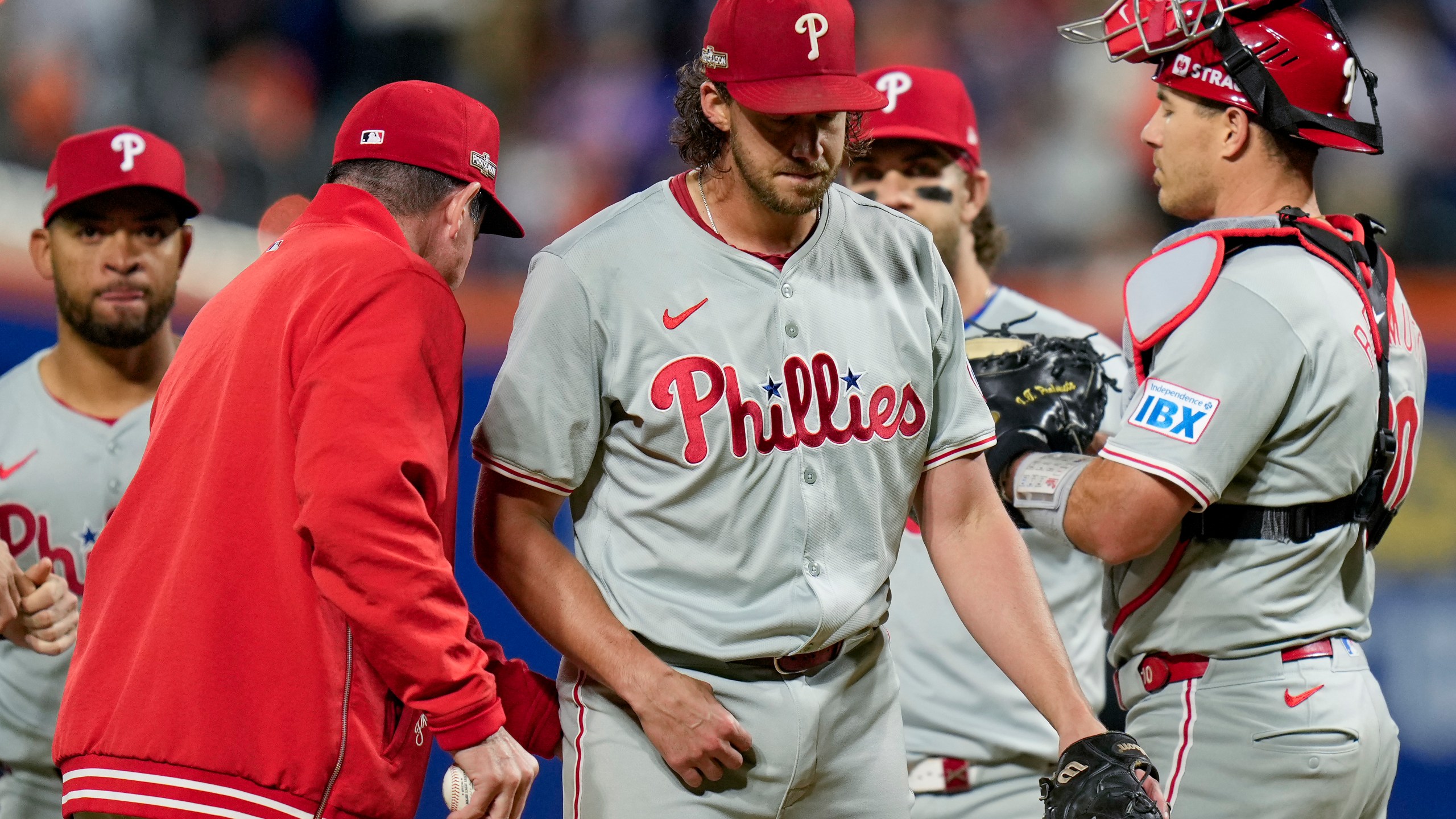 Philadelphia Phillies pitcher Aaron Nola is relieved by manager Rob Thomson during the sixth inning of Game 3 of the National League baseball playoff series against the New York Mets, Tuesday, Oct. 8, 2024, in New York. (AP Photo/Seth Wenig)