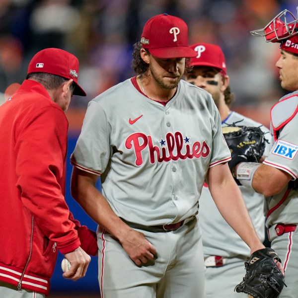 Philadelphia Phillies pitcher Aaron Nola is relieved by manager Rob Thomson during the sixth inning of Game 3 of the National League baseball playoff series against the New York Mets, Tuesday, Oct. 8, 2024, in New York. (AP Photo/Seth Wenig)