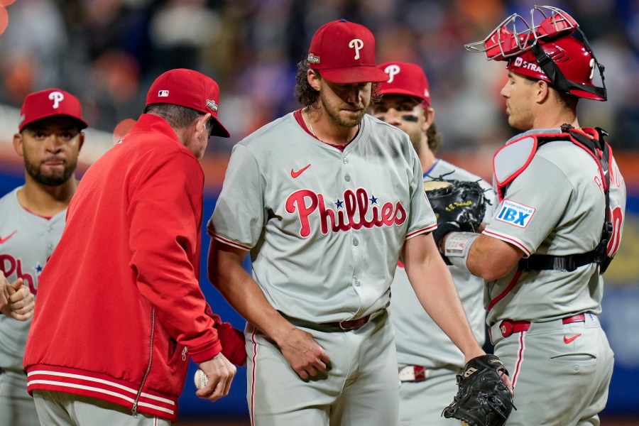 Philadelphia Phillies pitcher Aaron Nola is relieved by manager Rob Thomson during the sixth inning of Game 3 of the National League baseball playoff series against the New York Mets, Tuesday, Oct. 8, 2024, in New York. (AP Photo/Seth Wenig)