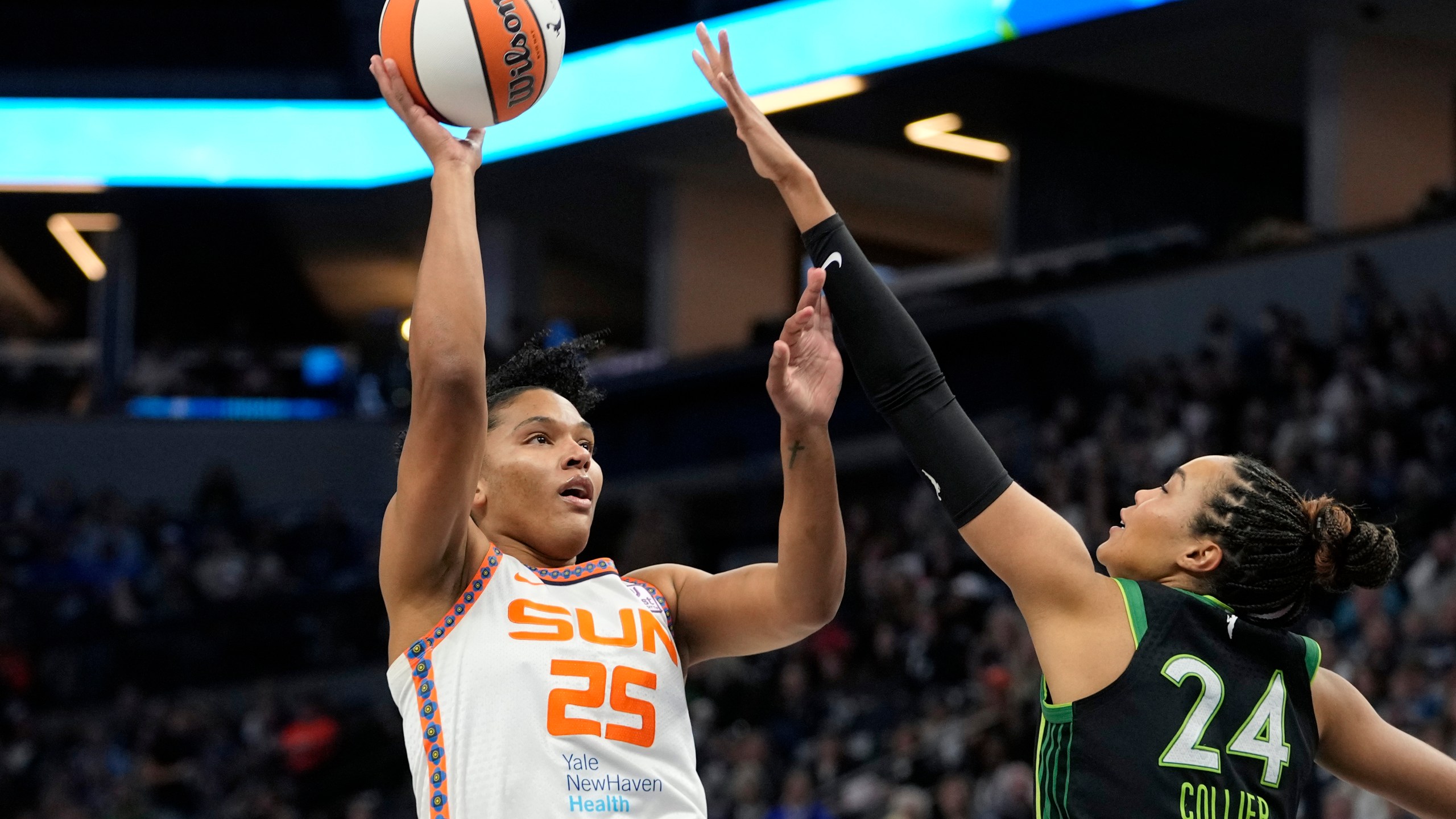 Connecticut Sun forward Alyssa Thomas (25) shoots over Minnesota Lynx forward Napheesa Collier (24) during the first half of Game 5 of a WNBA basketball semifinals, Tuesday, Oct. 8, 2024, in Minneapolis. (AP Photo/Abbie Parr)