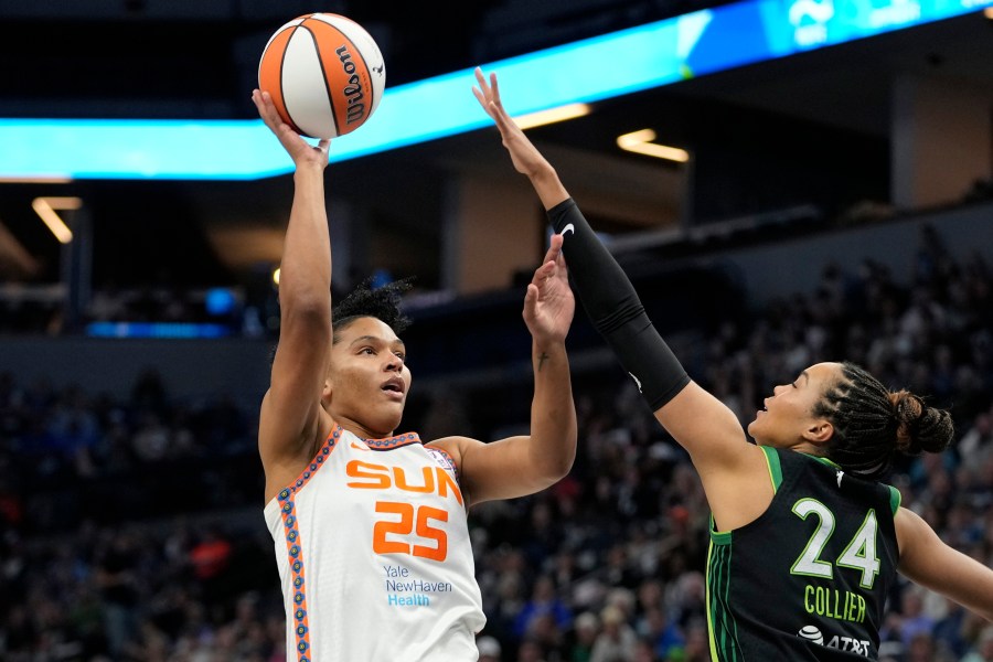 Connecticut Sun forward Alyssa Thomas (25) shoots over Minnesota Lynx forward Napheesa Collier (24) during the first half of Game 5 of a WNBA basketball semifinals, Tuesday, Oct. 8, 2024, in Minneapolis. (AP Photo/Abbie Parr)