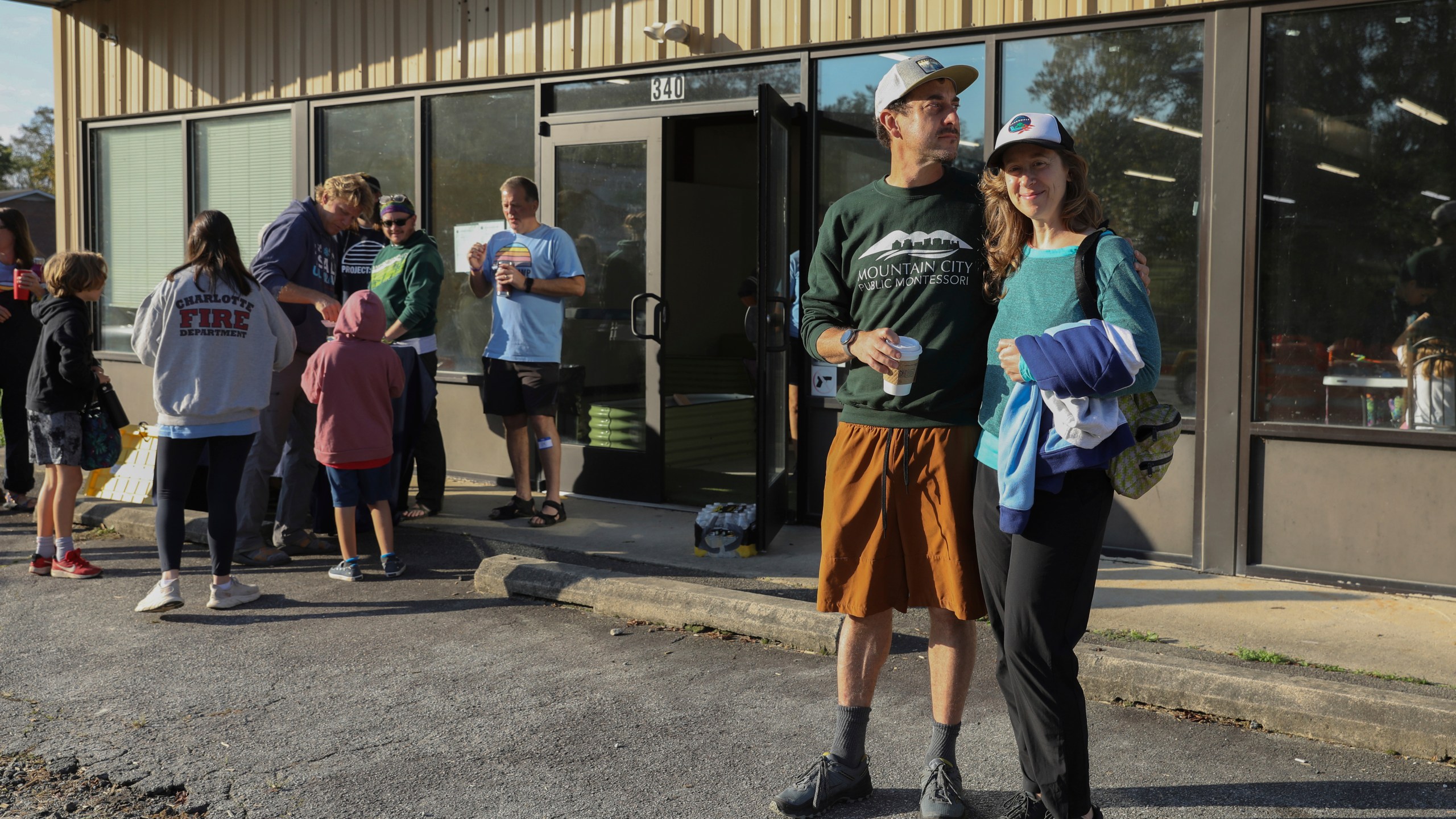 Max and Aviva Weissman stand outside the Boys and Girls Club of Transylvania County in Brevard, N.C., Tuesday, Oct. 8, 2024 after dropping off their kids at Project Camp. (AP Photo/Gabriela Aoun Angueira)