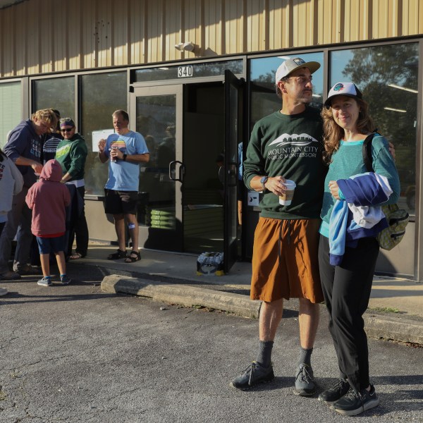 Max and Aviva Weissman stand outside the Boys and Girls Club of Transylvania County in Brevard, N.C., Tuesday, Oct. 8, 2024 after dropping off their kids at Project Camp. (AP Photo/Gabriela Aoun Angueira)