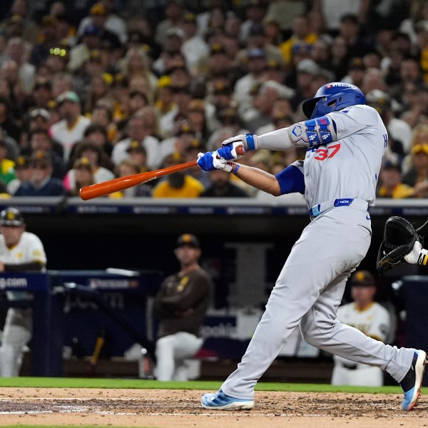 Los Angeles Dodgers' Teoscar Hernández connects for a grand slam during the third inning in Game 3 of a baseball NL Division Series against the San Diego Padres, Tuesday, Oct. 8, 2024, in San Diego. (AP Photo/Gregory Bull)