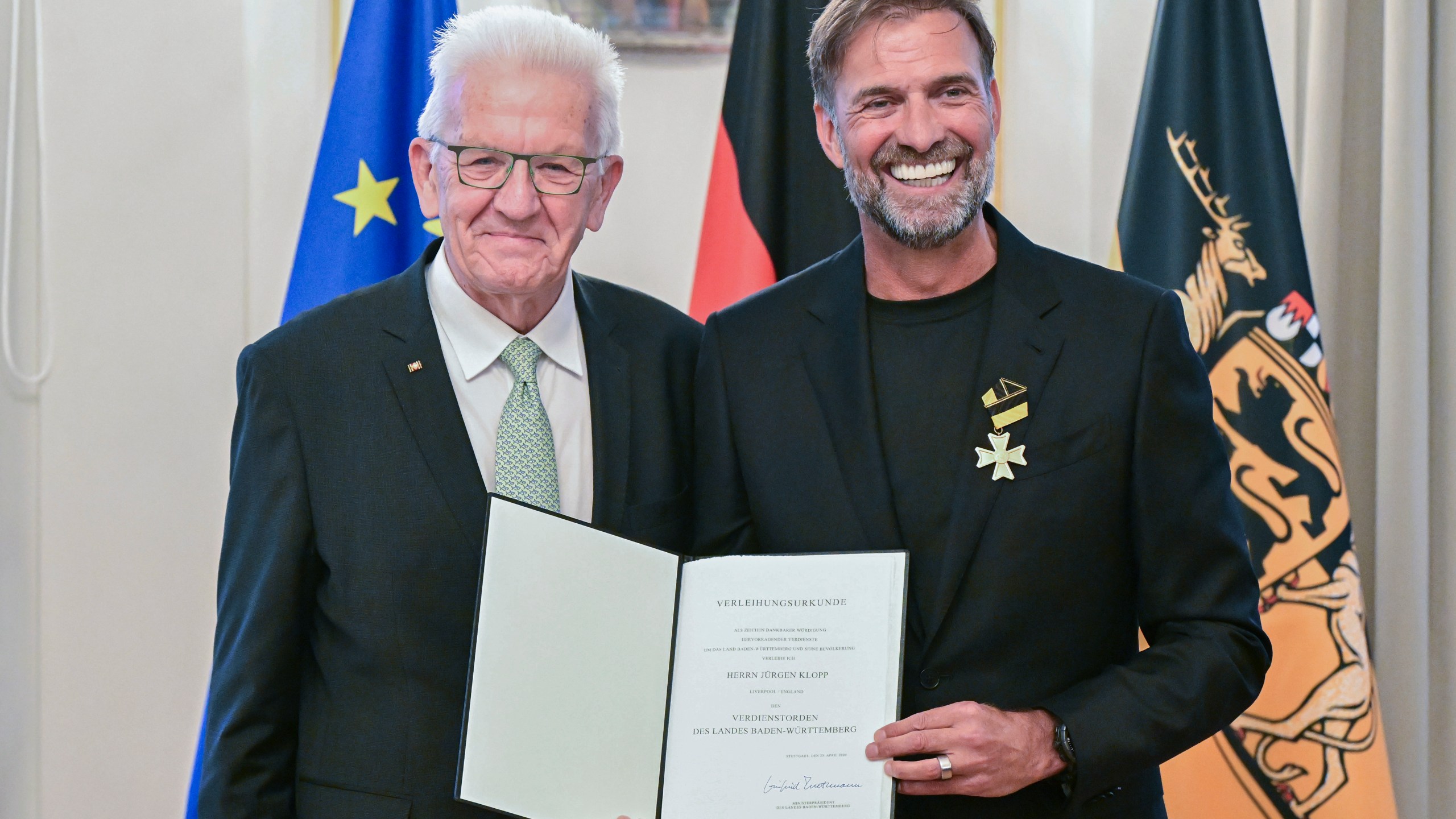 Soccer coach Juergen Klopp, right, receives the Order of Merit of the German State of Baden-Wuerttemberg in Stuttgart, Germany, Tuesday, Oct. 8, 2024, from Governor Winfried Kretschmann, left, for his wide-ranging social commitment outside of sport. (Bernd Weissbrod/dpa via AP)