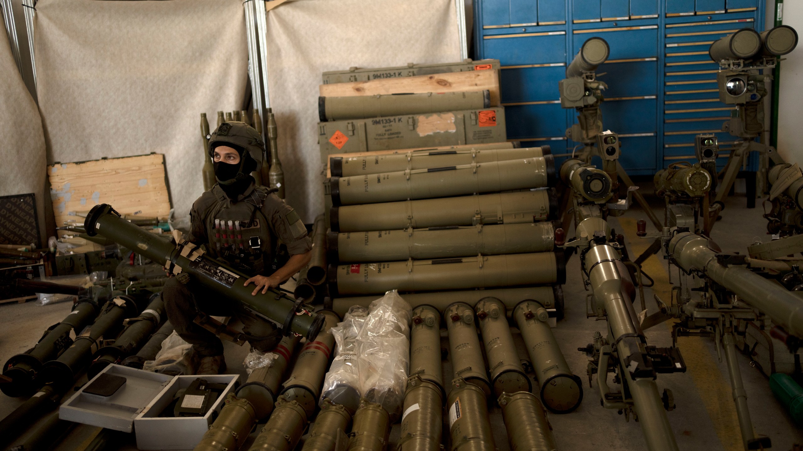 An Israeli soldier from an EOD (explosive ordnance disposal) poses with a weapon used by Hezbollah seized during combat operations in Lebanon displayed during a government-organized media tour on a base in southern Israel, Wednesday, Oct. 9, 2024. (AP Photo/Maya Alleruzzo)