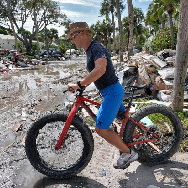 FILE - Arnie Bellini surveys the damages caused from Hurricane Helene on a street in Clearwater Beach, Fla., Oct. 8, 2024. (AP Photo/Chris O'Meara, File)