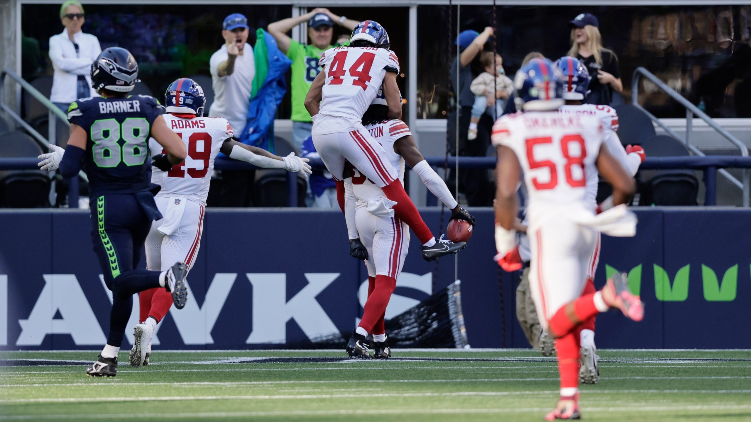 EDS NOTE: OBSCENITY - New York Giants wide receiver Bryce Ford-Wheaton (88), back, center, celebrates with teammates after returning a blocked field goal for a touchdown during the second half of an NFL football game against the Seattle Seahawks, Sunday, Oct. 6, 2024, in Seattle. (AP Photo/John Froschauer)