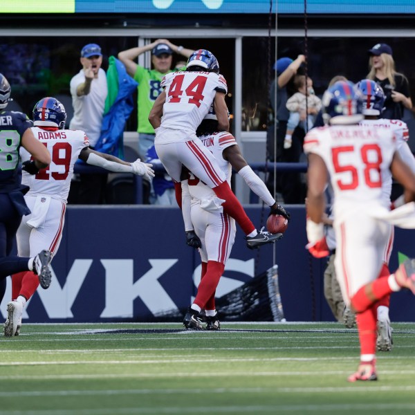 EDS NOTE: OBSCENITY - New York Giants wide receiver Bryce Ford-Wheaton (88), back, center, celebrates with teammates after returning a blocked field goal for a touchdown during the second half of an NFL football game against the Seattle Seahawks, Sunday, Oct. 6, 2024, in Seattle. (AP Photo/John Froschauer)