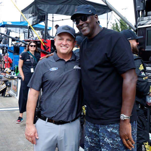 Bob Jenkins, owner of Front Row Motorsports and Co-Owner Michael Jordan, of 23XI Racing, pose before a NASCAR Cup Series auto race at Talladega Superspeedway, Sunday, Oct. 6, 2024, in Talladega, Ala. (AP Photo/ Butch Dill)