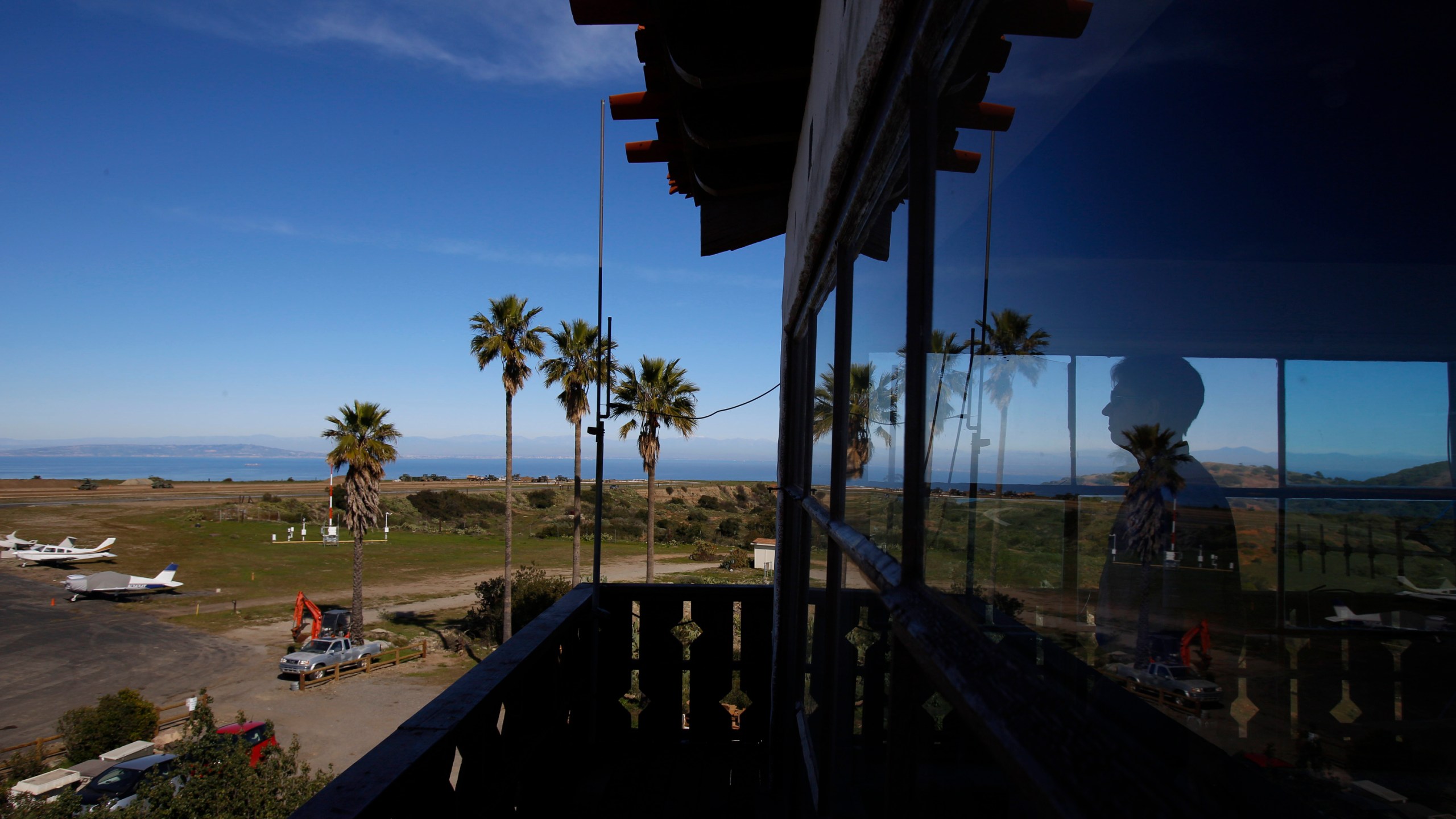 FILE - Catalina Island Conservancy Airport Manager Justin Bollum looks out of the airport tower as U.S. Marines and Navy Seabees rebuild the mountaintop runway on Santa Catalina Island, Calif., Friday, Jan. 25, 2019. (AP Photo/Damian Dovarganes, File)