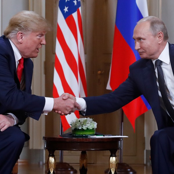 FILE - U.S. President Donald Trump, left, and Russian President Vladimir Putin, right, shake hands at the beginning of a meeting at the Presidential Palace in Helsinki, Finland, July 16, 2018. (AP Photo/Pablo Martinez Monsivais, File)