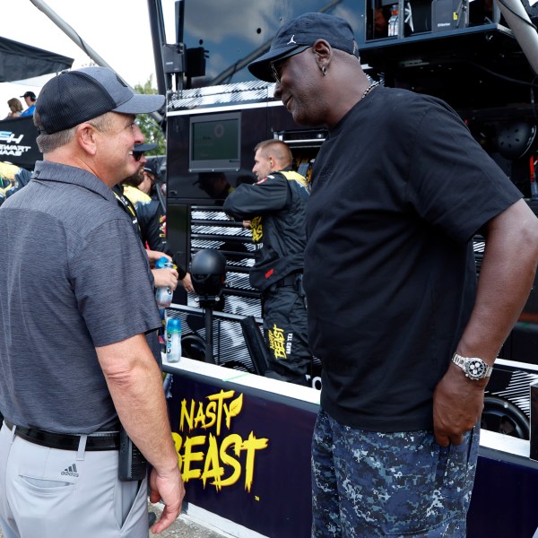 Bob Jenkins, owner of Front Row Motorsports and Co-Owner Michael Jordan, of 23XI Racing, talk before a NASCAR Cup Series auto race at Talladega Superspeedway, Sunday, Oct. 6, 2024, in Talladega, Ala. (AP Photo/ Butch Dill)