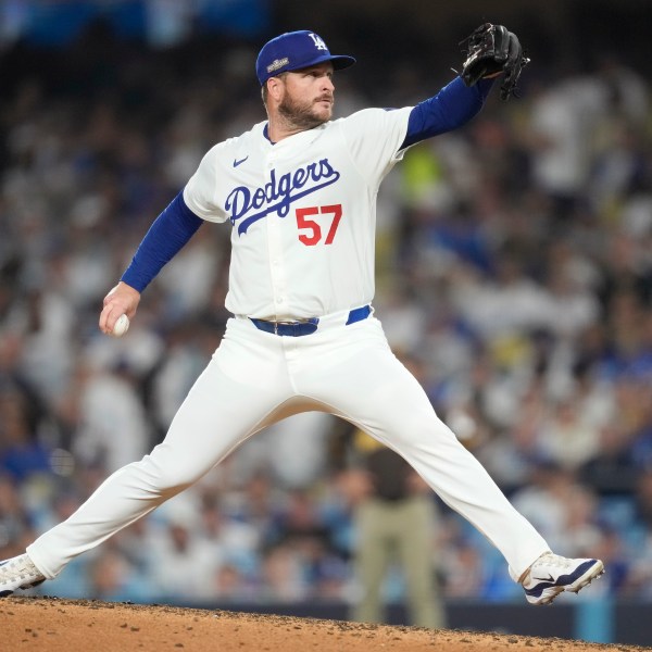 Los Angeles Dodgers pitcher Ryan Brasier throws to a San Diego Padres batter during the eighth inning in Game 2 of a baseball NL Division Series, Sunday, Oct. 6, 2024, in Los Angeles. (AP Photo/Ashley Landis)