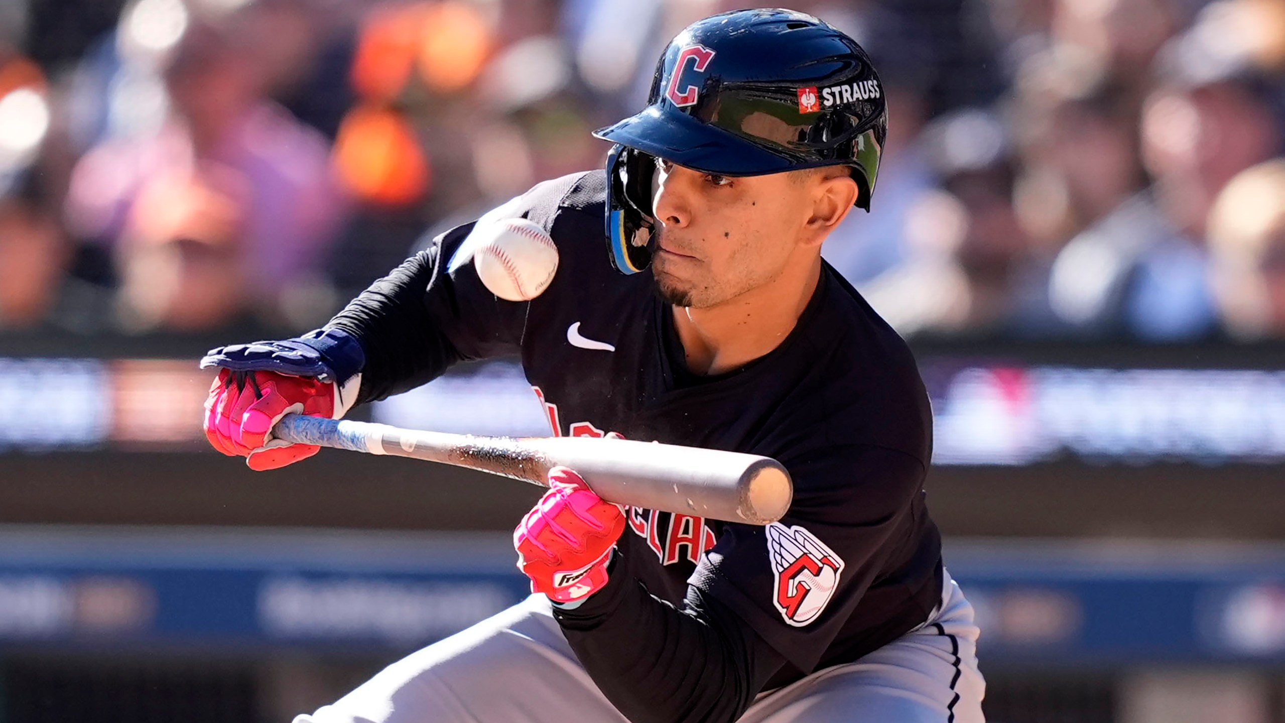 Cleveland Guardians second base Andrés Giménez bunts in the second inning during Game 3 of a baseball American League Division Series against the Detroit Tigers, Wednesday, Oct. 9, 2024, in Detroit. (AP Photo/Carlos Osorio)