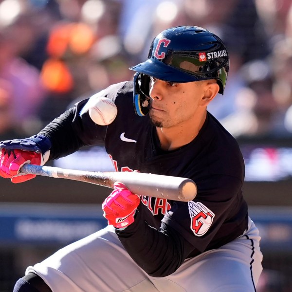 Cleveland Guardians second base Andrés Giménez bunts in the second inning during Game 3 of a baseball American League Division Series against the Detroit Tigers, Wednesday, Oct. 9, 2024, in Detroit. (AP Photo/Carlos Osorio)