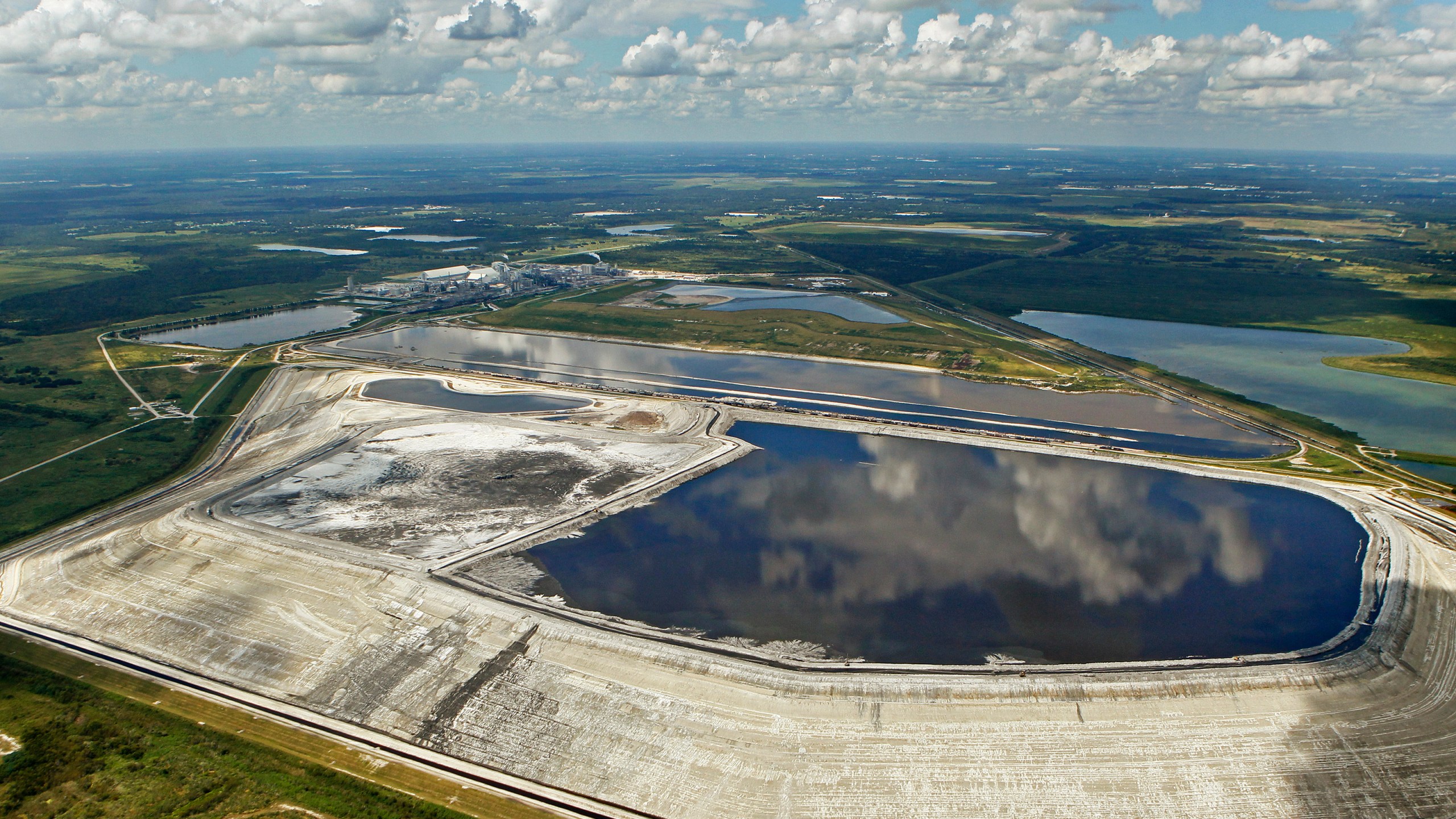 FILE - A sinkhole that opened up underneath a gypsum stack at a Mosaic phosphate fertilizer plant is seen in Mulberry, Fla., on Sept. 16, 2016. (Jim Damaske/Tampa Bay Times via AP, File)