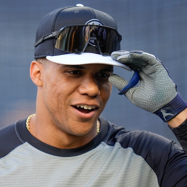 New York Yankees outfielder Juan Soto (22) warms up before playing against the Kansas City Royals in Game 2 of the American League baseball playoff series, Monday, Oct. 7, 2024, in New York. (AP Photo/Seth Wenig)