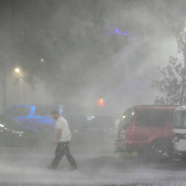 Max Watts, of Buford, Ga., walks in the parking lot to check on a trailer parked outside the hotel where he is riding out Hurricane Milton with coworkers, Wednesday, Oct. 9, 2024, in Tampa, Fla. Watts, who works for a towing company, was deployed with colleagues to Florida to aid in the aftermath of the storm. (AP Photo/Julio Cortez)