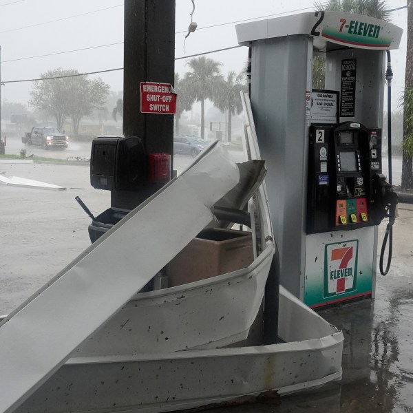 An apparent tornado caused by Hurricane Milton, tore the awning off a 7-Eleven convenient store, Wednesday, Oct. 9, 2024, in Cape Coral, Fla.(AP Photo/Marta Lavandier)