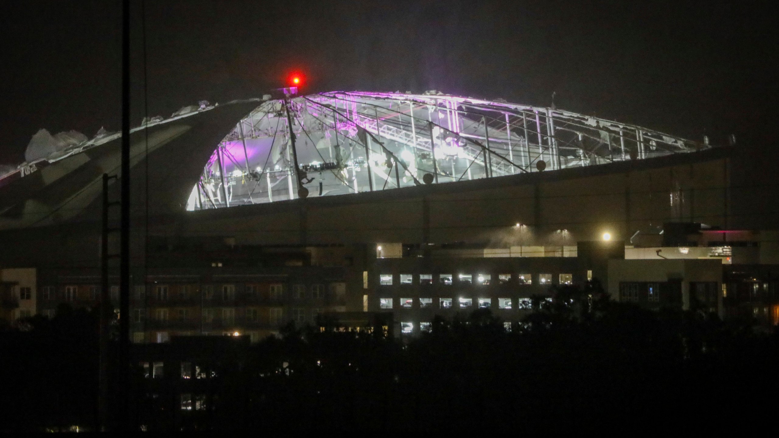 The roof of Tropicana Field, the home of the Tampa Bay Rays, appeared to be badly damaged as Hurricane Milton passes Thursday, Oct. 10, 2024, in St. Petersburg, Fla. (Chris Urso/Tampa Bay Times via AP)