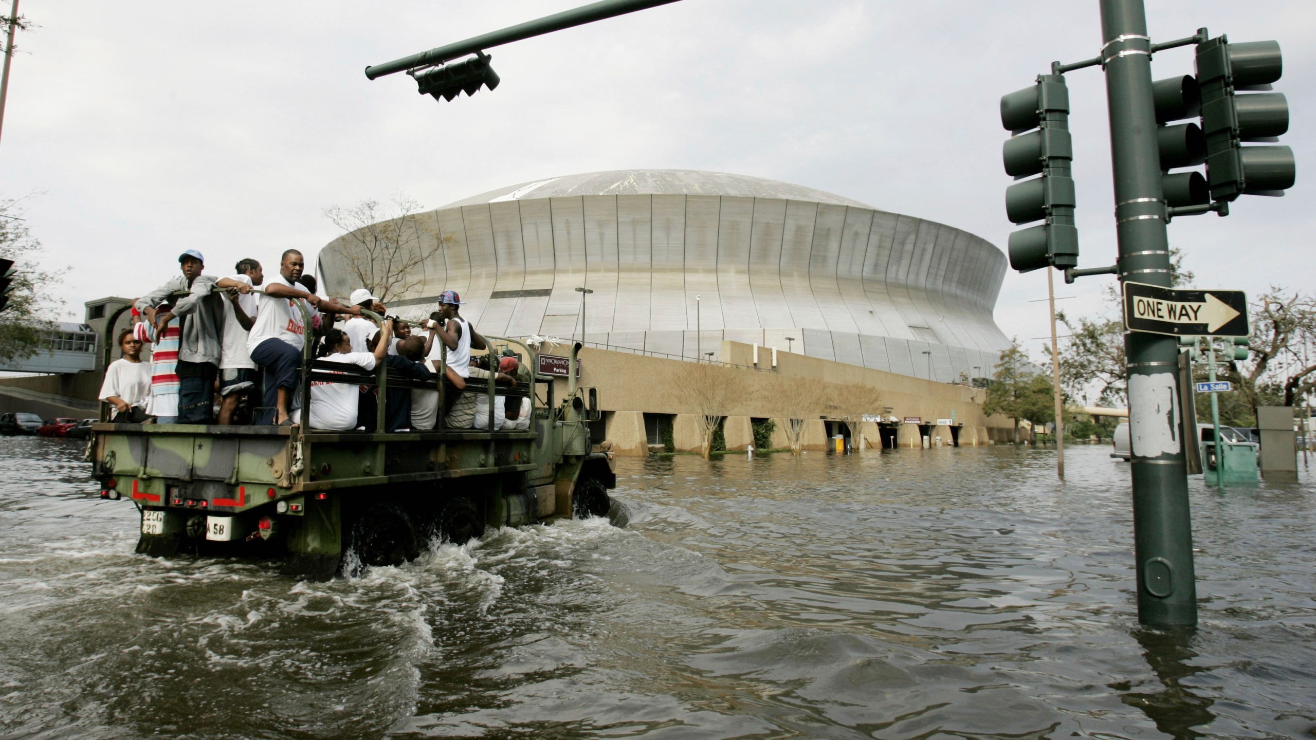 FILE - National Guard trucks haul residents through floodwaters to the Superdome after Hurricane Katrina hit in New Orleans, Aug. 30, 2005. (AP Photo/Eric Gay, File)