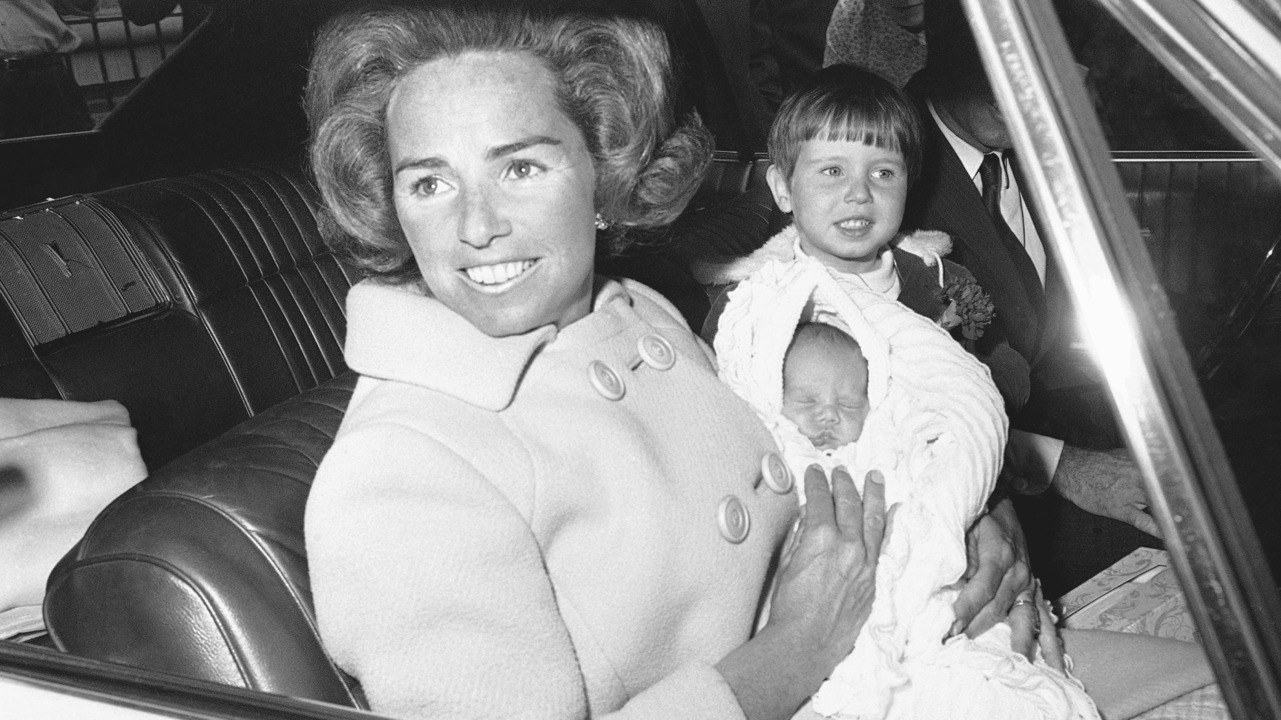 FILE - Ethel Kennedy holds her new son, Douglas Harriman Kennedy, with two-year-old Christopher Kennedy, right, as they leave Georgetown University in Washington, April 13, 1967, for home. (AP Photo/Henry Burroughs, File)