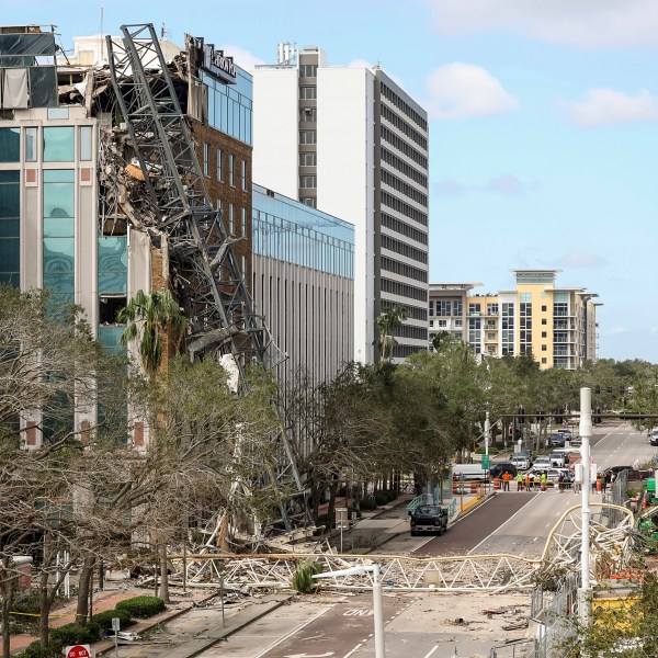 A high rise construction crane broke apart and crashed into the building across the street during Hurricane Milton on Thursday, Oct. 10, 2024, in St. Petersburg, Fla. (AP Photo/Mike Carlson)