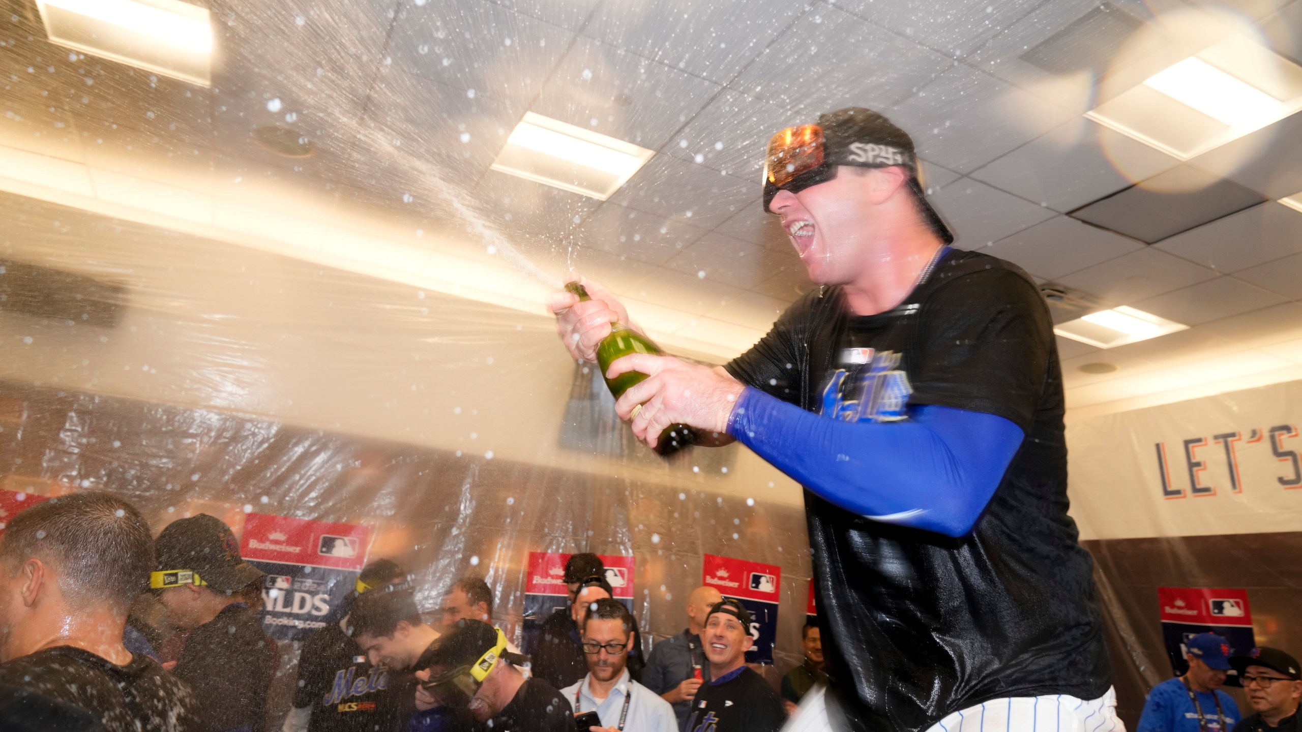 New York Mets' Pete Alonso celebrates in the locker room after defeating the Philadelphia Phillies in Game 4 of the National League baseball playoff series, Wednesday, Oct. 9, 2024, in New York. (AP Photo/Frank Franklin II)