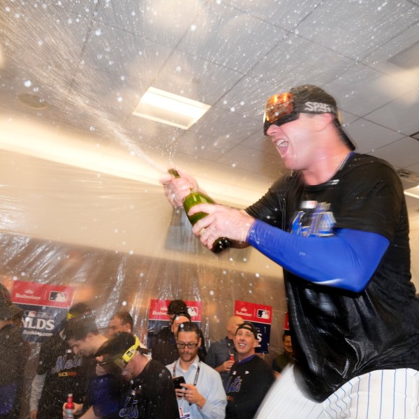 New York Mets' Pete Alonso celebrates in the locker room after defeating the Philadelphia Phillies in Game 4 of the National League baseball playoff series, Wednesday, Oct. 9, 2024, in New York. (AP Photo/Frank Franklin II)