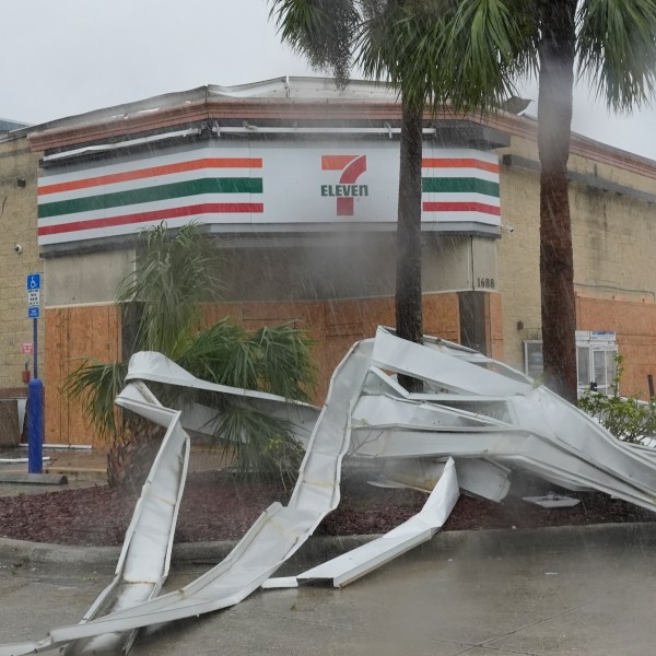 An apparent tornado caused by Hurricane Milton, tore the awning off a 7-Eleven convenient store, Wednesday, Oct. 9, 2024, in Cape Coral, Fla. (AP Photo/Marta Lavandier)