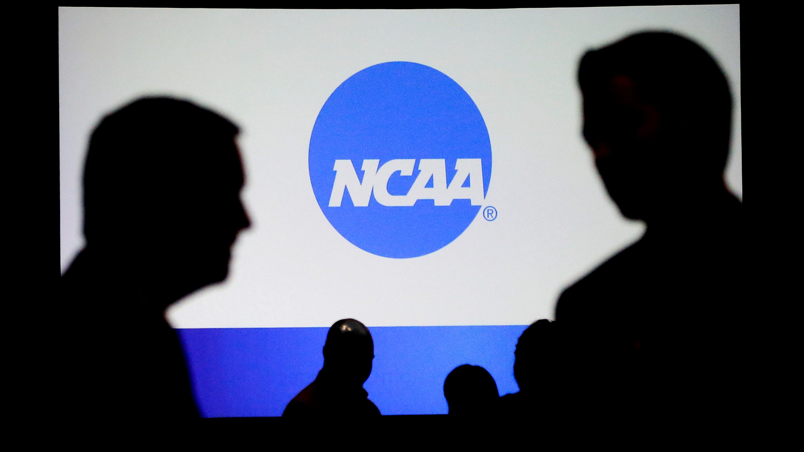 FILE - People talk after a panel discussion at the NCAA Convention, Jan. 19, 2017, in Nashville, Tenn. (AP Photo/Mark Humphrey, File)