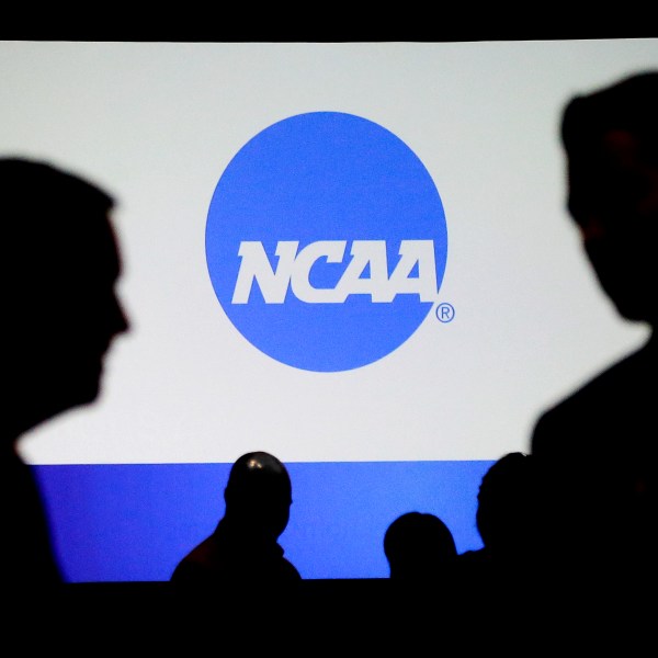 FILE - People talk after a panel discussion at the NCAA Convention, Jan. 19, 2017, in Nashville, Tenn. (AP Photo/Mark Humphrey, File)